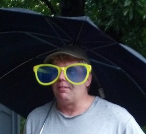 Paul with big glasses and umbrella